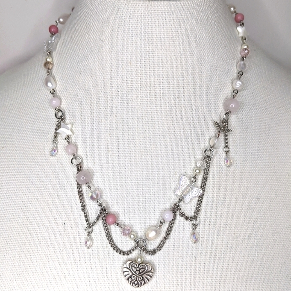 Necklace with pearls chain and heart pendant and is pink. Handmade by the.